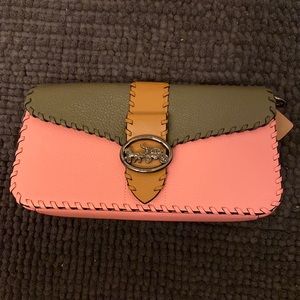 Brand new, never used Coach clutch with shoulder strap